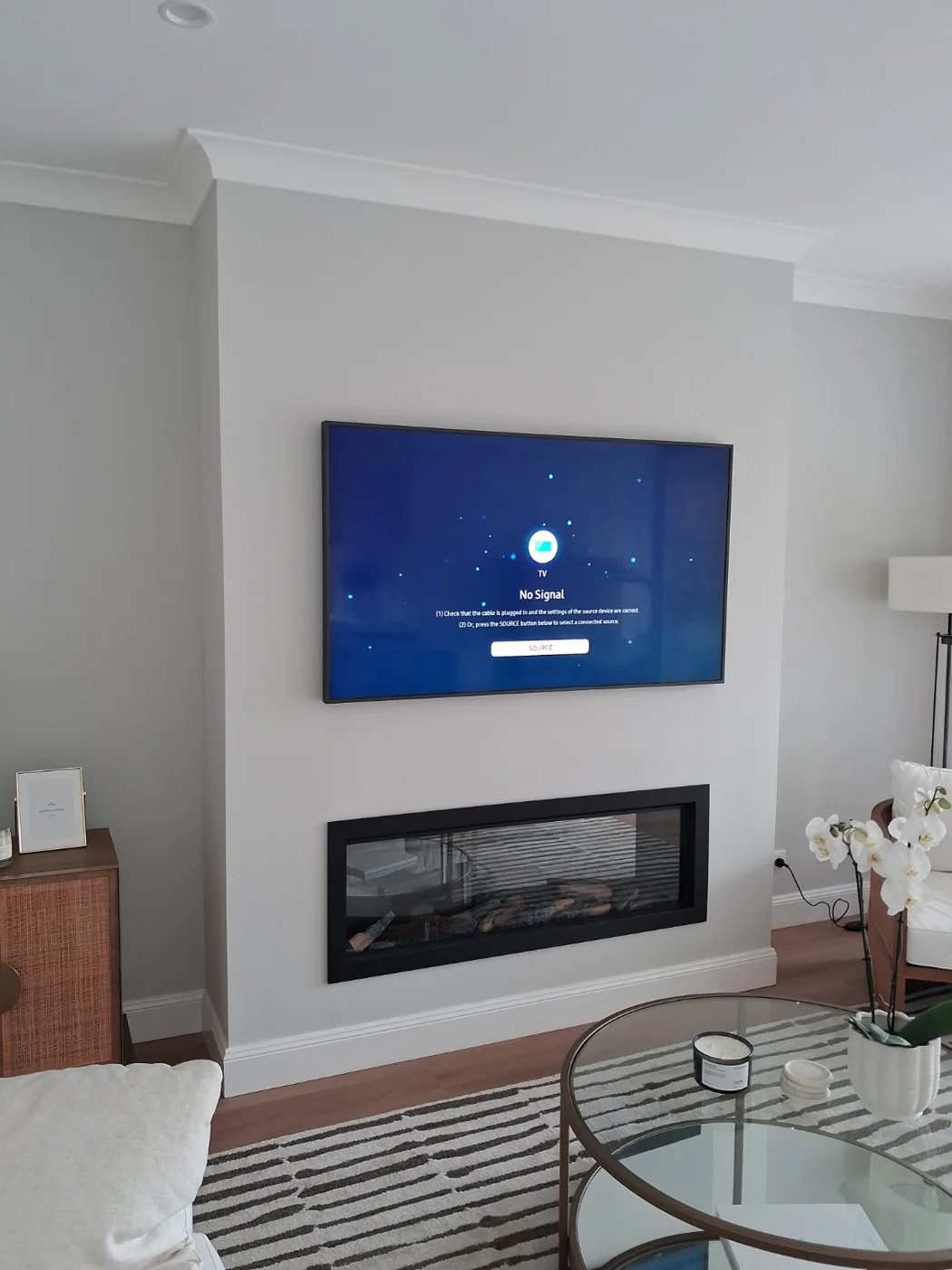 Wall-mounted television above the existing fireplace.