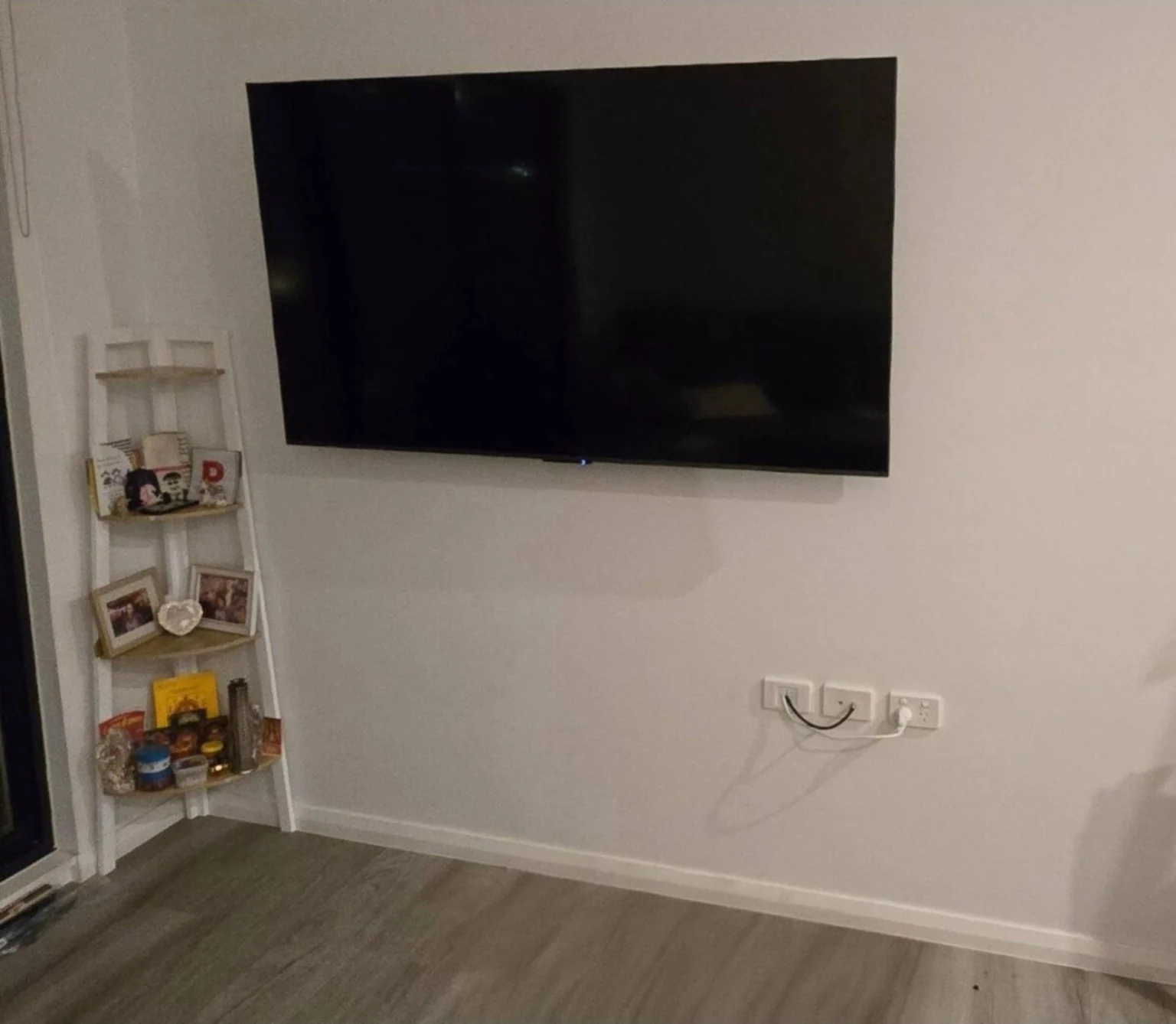 A TV installation with connections below the screen.