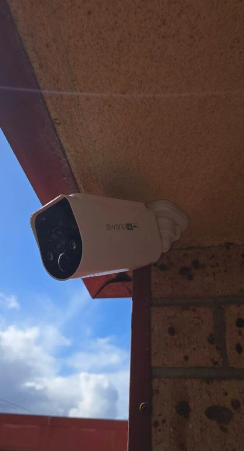 A camera mounted beneath a roof overhang.