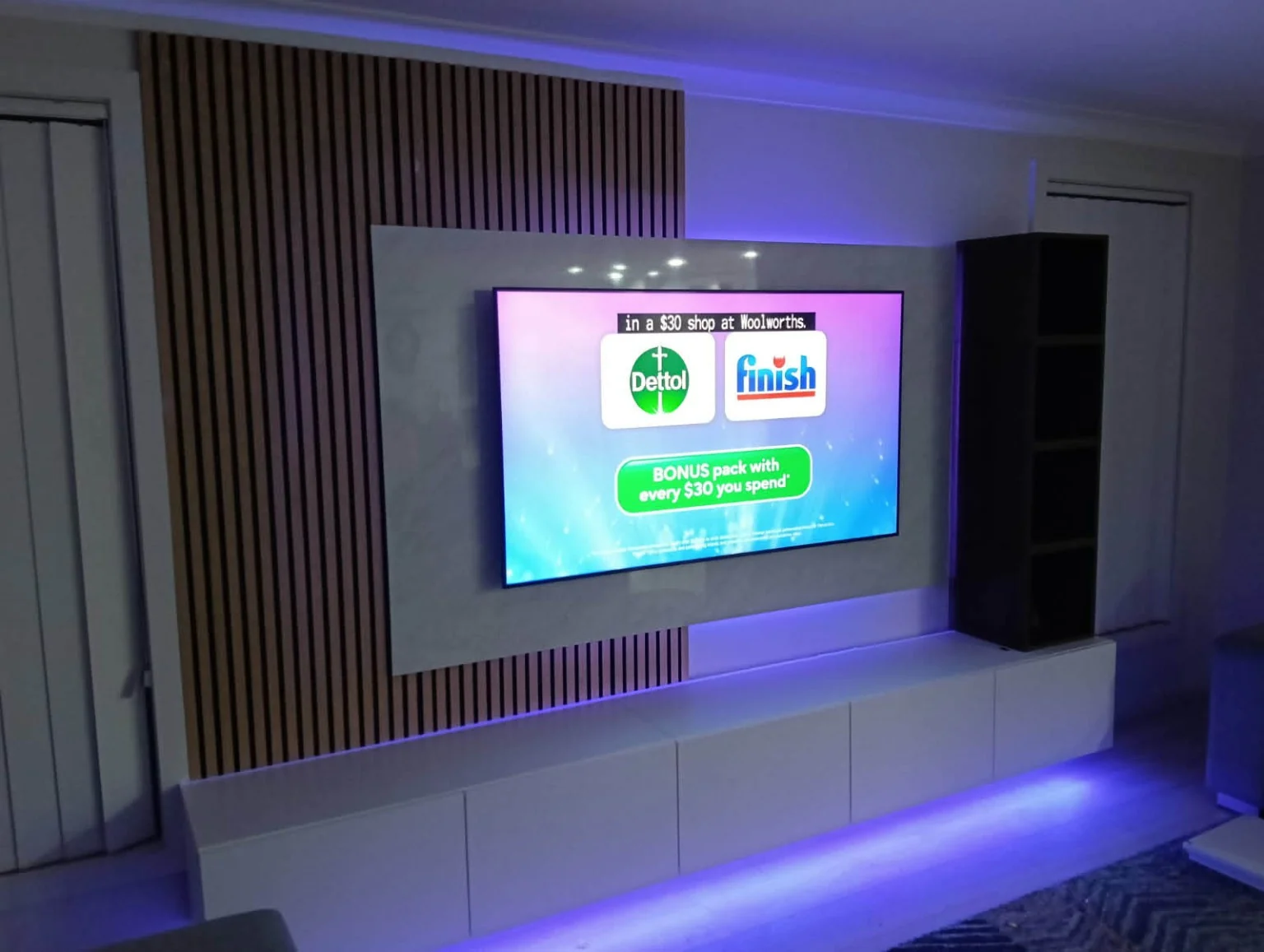 A closer view of the screen, feature panel and cabinetry.